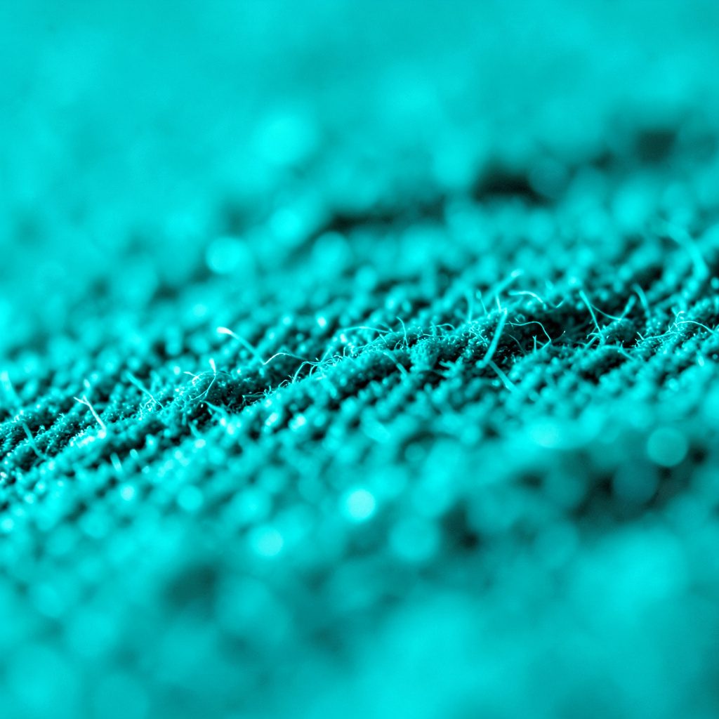 A dark teal and charcoal abstract texture with subtle geometric patterns, suggesting a technical conference atmosphere